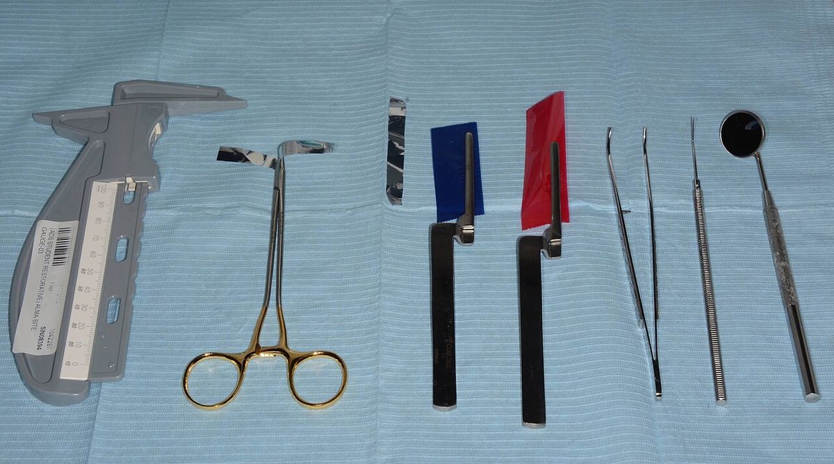 Dental examination instruments laid out on a blue cloth